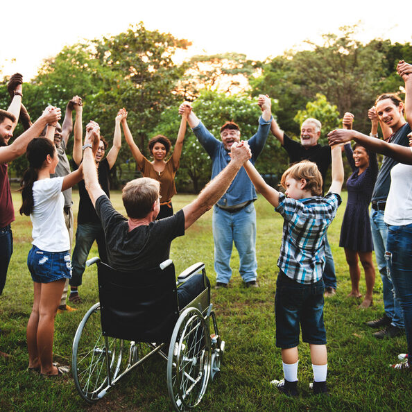 Group of people holding hand together in the park