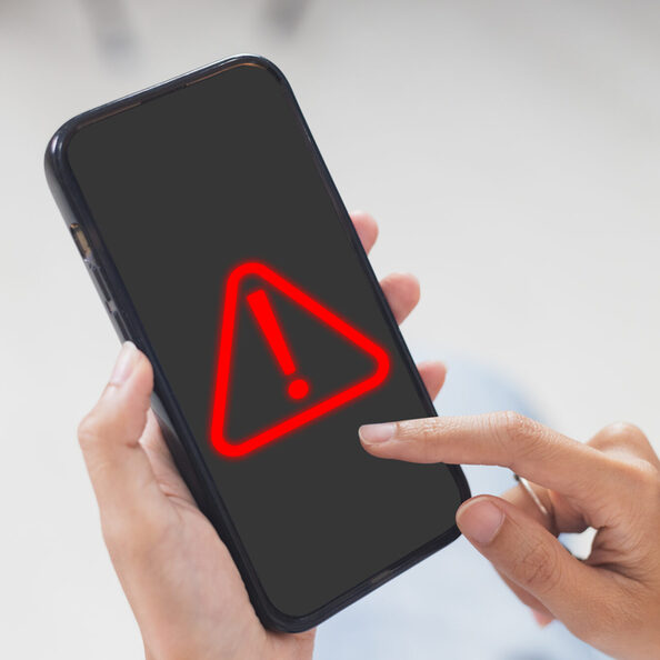 woman using smartphone with notification error. warning sign over on mobile phone. maintenance connection application. programmer, developer. security network dangerous.
