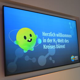 Bildschirm mit "Herzlich willkommen in der H2-Welt des Kreises Düren"