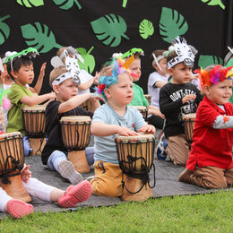 Kinder trommeln beim Jubiläums-Fest der Kita Sonnenschein in Jülich.
