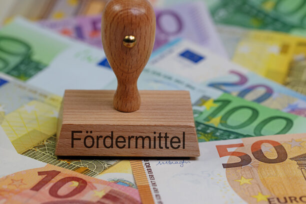 Stempel mit der Aufschrift "Fördermittel" auf Geldscheinen